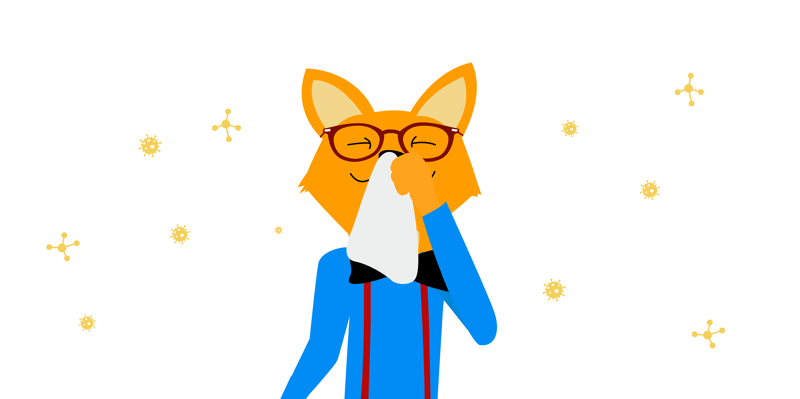 The smart-home fox smiles calmly and holds a cloth over his nose to protect himself from allergens.